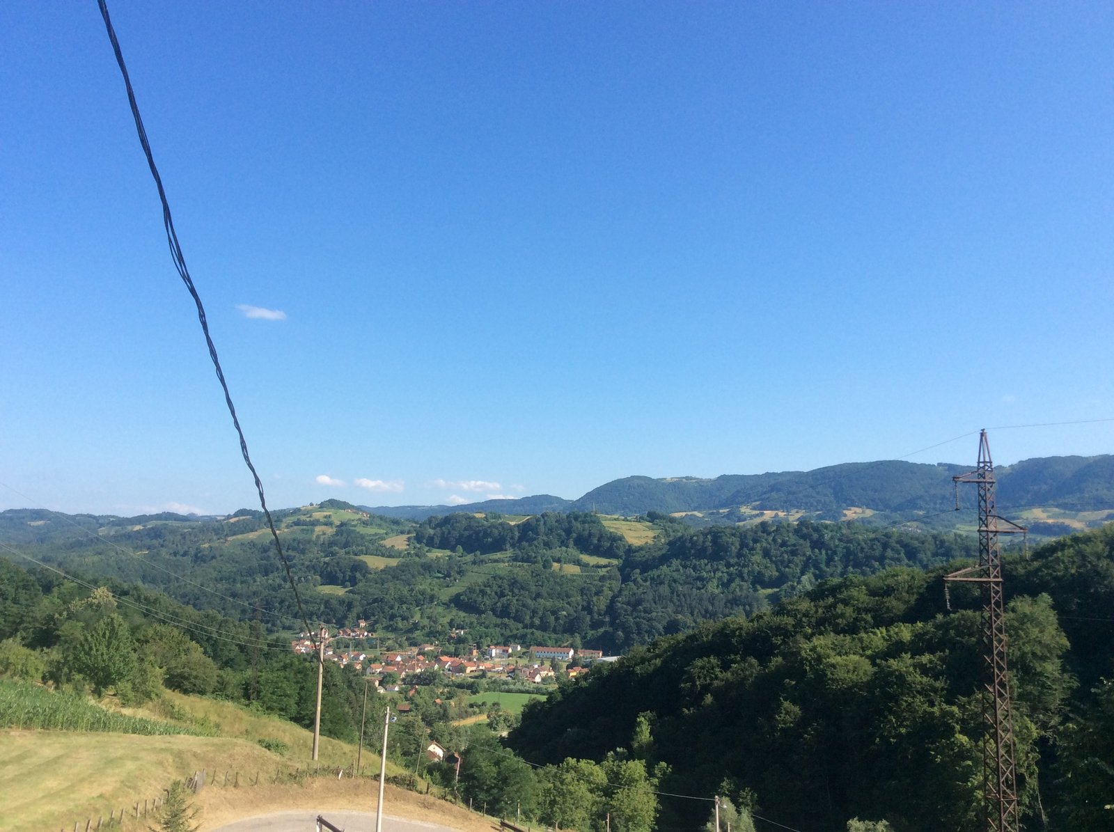 Wide view of Krupanj town in its valley, photographed from Dobri Potok with the surrounding hills behind