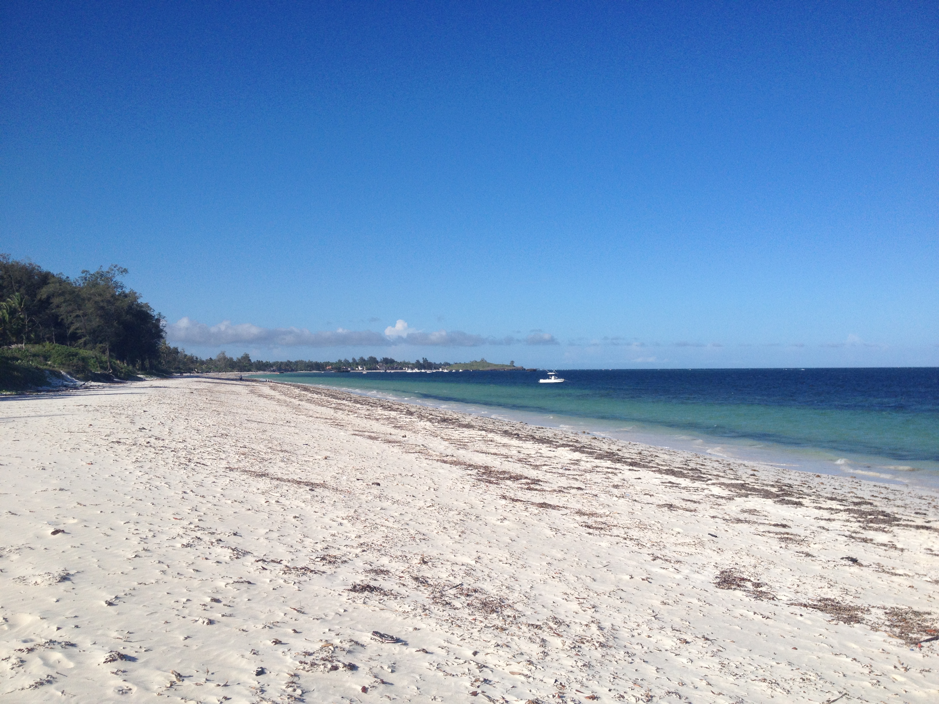 View across Watamu Bay on the Kenyan Indian Ocean coast, turquoise shallows curving along a white-sand shoreline